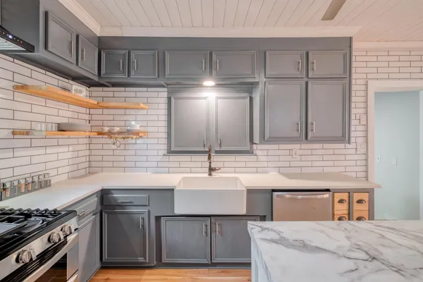 a kitchen with sink cabinets and stove