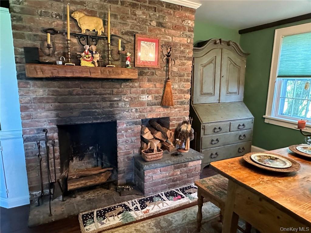 477 Canoe Hill Road Millbrook, NY 12545 - Photo 6 of 11 Dining space featuring brick fireplace, and crown molding