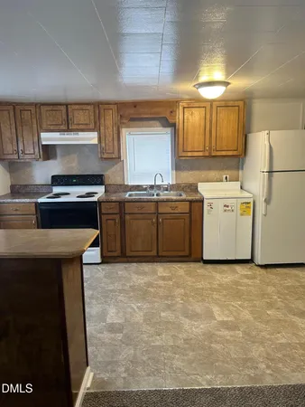 a kitchen with stainless steel appliances granite countertop a stove a sink dishwasher and a refrigerator