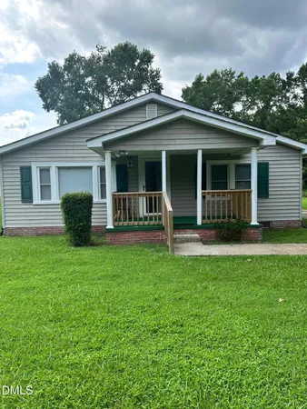 a view of a house with a yard and plants