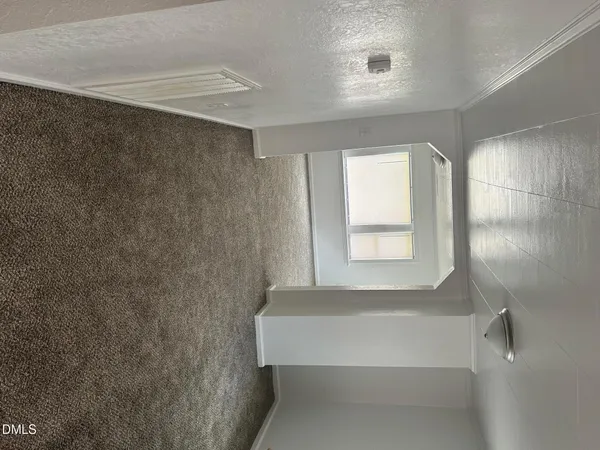 a bathroom with a bathtub and a window