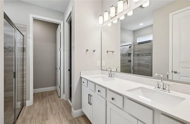 a bathroom with a sink double vanity and shower