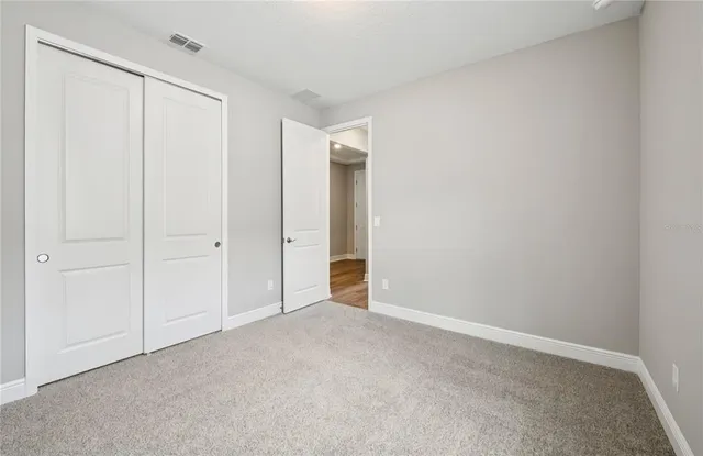 a view of an empty room and closet area