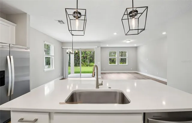 a kitchen with a sink and a refrigerator