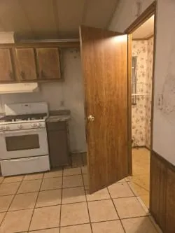 a kitchen with a stove top oven and cabinets