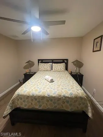 a bed sitting in a bedroom next to a lamp