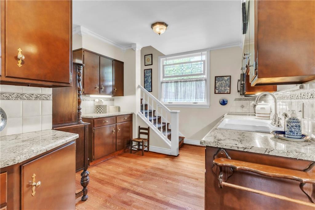 223 Belmont Road Butler, PA 16001 - Photo 21 of 50 a kitchen with stainless steel appliances granite countertop a sink stove and wooden cabinets