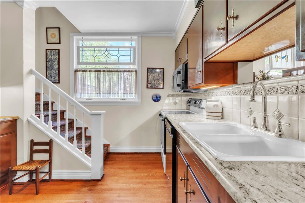 223 Belmont Road Butler, PA 16001 - Photo 22 of 50 a kitchen with stainless steel appliances granite countertop a sink a stove and a wooden floors