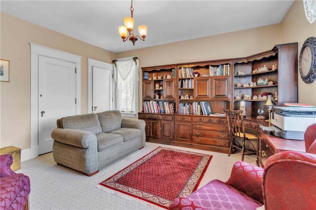223 Belmont Road Butler, PA 16001 - Photo 38 of 50 a living room with furniture a bookshelf and a book shelf