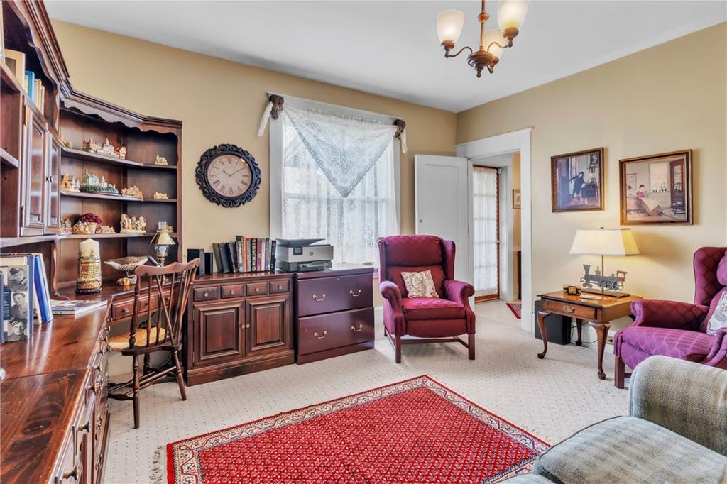 223 Belmont Road Butler, PA 16001 - Photo 39 of 50 a living room with furniture a clock on wall and a window