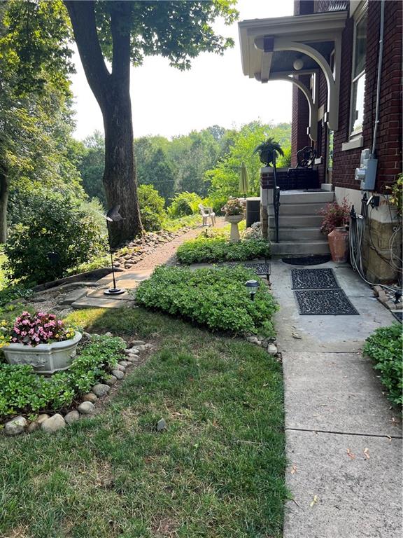 223 Belmont Road Butler, PA 16001 - Photo 48 of 50 a view of a garden with a tree in the background