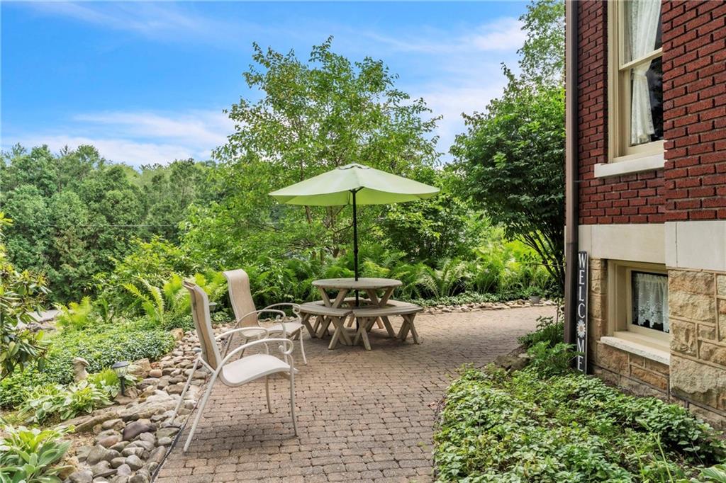 223 Belmont Road Butler, PA 16001 - Photo 9 of 50 a view of a patio with furniture and table under an umbrella