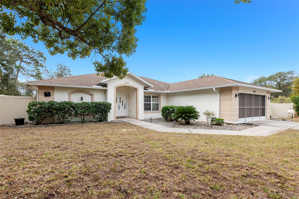 8382 Windridge Way Weeki Wachee, FL 34613 - Photo 1 of 1 a front view of a house with a yard and garage
