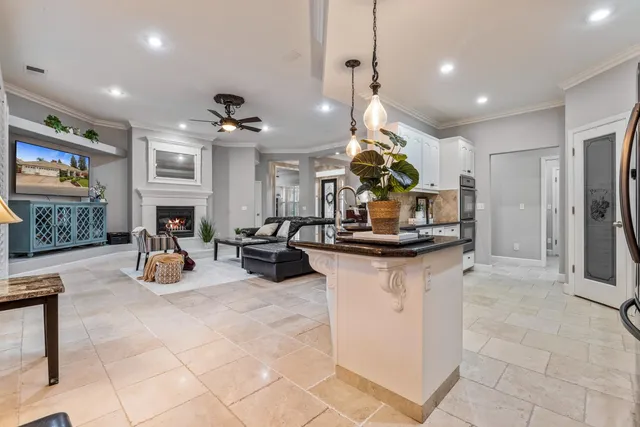 a view of a hallway to rooms and livingroom with furniture