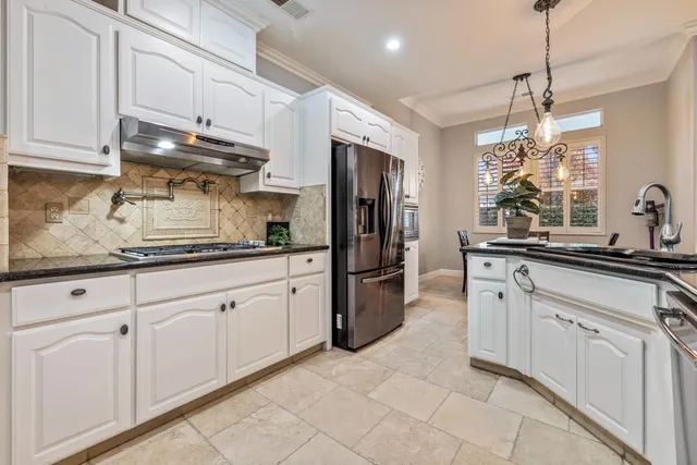 a bathroom with a granite countertop sink a mirror and a shower