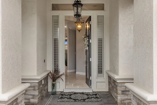 a view of a dining room with furniture and chandelier