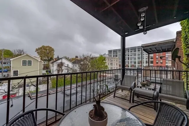 a view of a balcony with chairs
