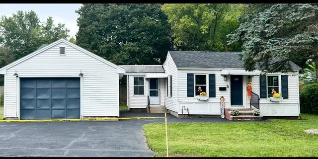 a view of a house with a backyard