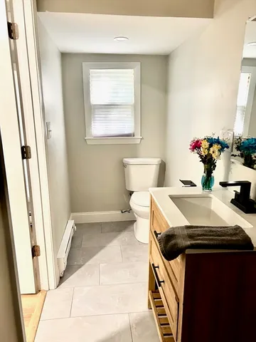 a bathroom with a sink toilet and a mirror