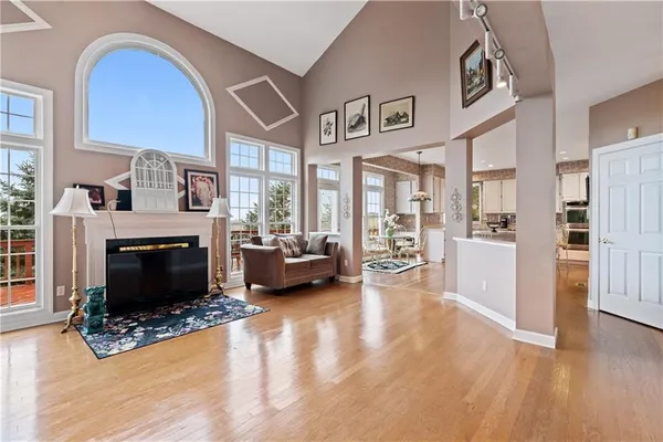 a living room with furniture large window and a fireplace