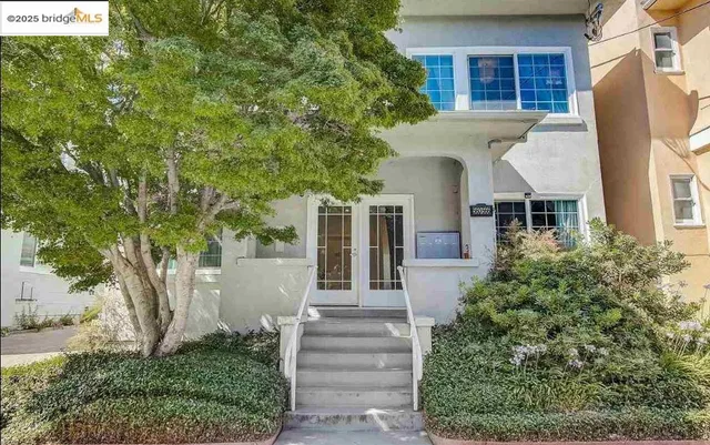 a front view of a house with a garden