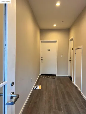 a view of a hallway with wooden floor
