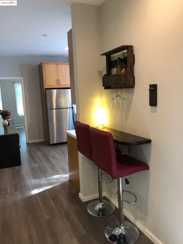 a kitchen with a refrigerator and a stove top oven