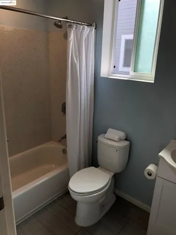 a bathroom with a toilet and a bathtub