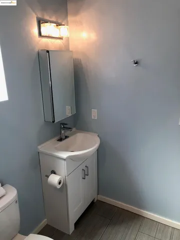 a bathroom with a sink a toilet and mirror