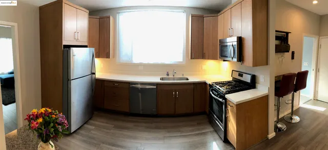 a kitchen with stainless steel appliances granite countertop a sink stove and a refrigerator