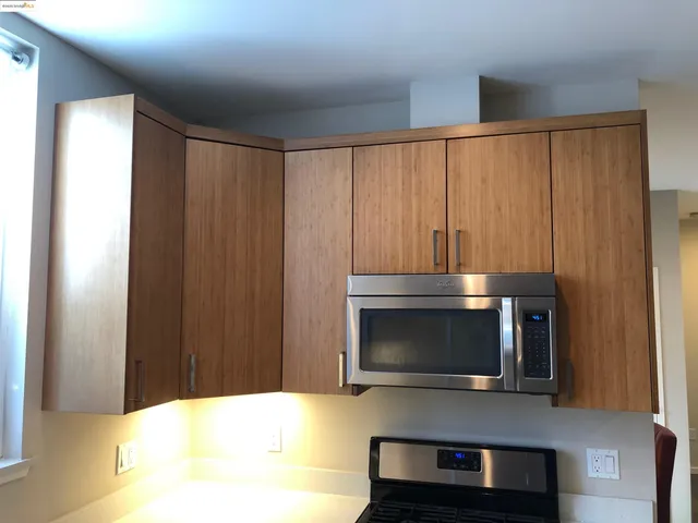 a kitchen with a stove and microwave