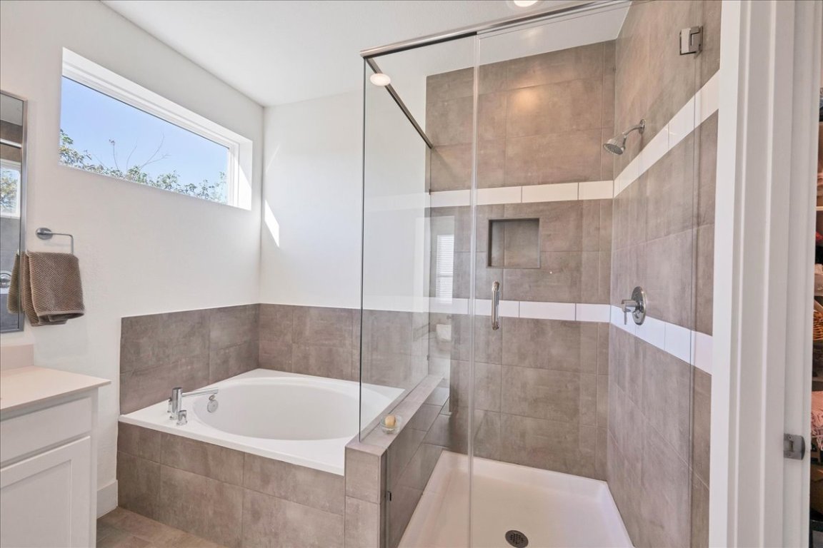 8922 Manchaca Road, Unit 906 Austin, TX 78748 - Photo 13 of 30 a bath tub sitting next to a white sink and vanity