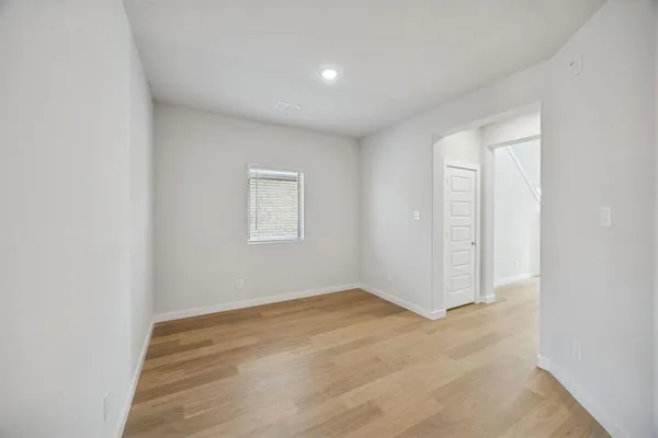 a view of a kitchen with kitchen island a sink wooden floor and a refrigerator