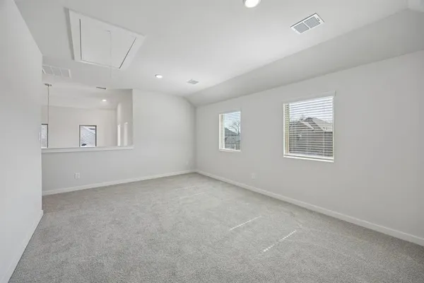 an empty room with windows and closet