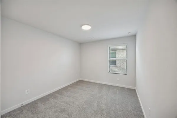 an empty room with a empty space and window