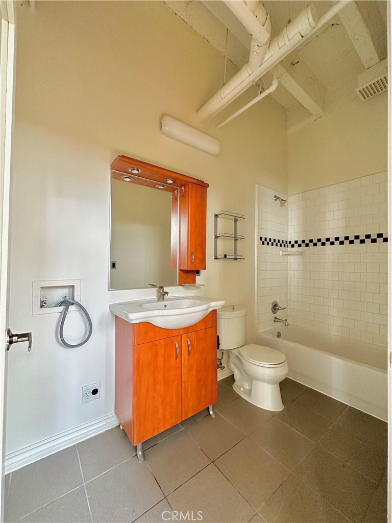 312 West 5th Street, Unit M1 Los Angeles, CA 90013 - Photo 7 of 8 a bathroom with a sink a toilet and shower