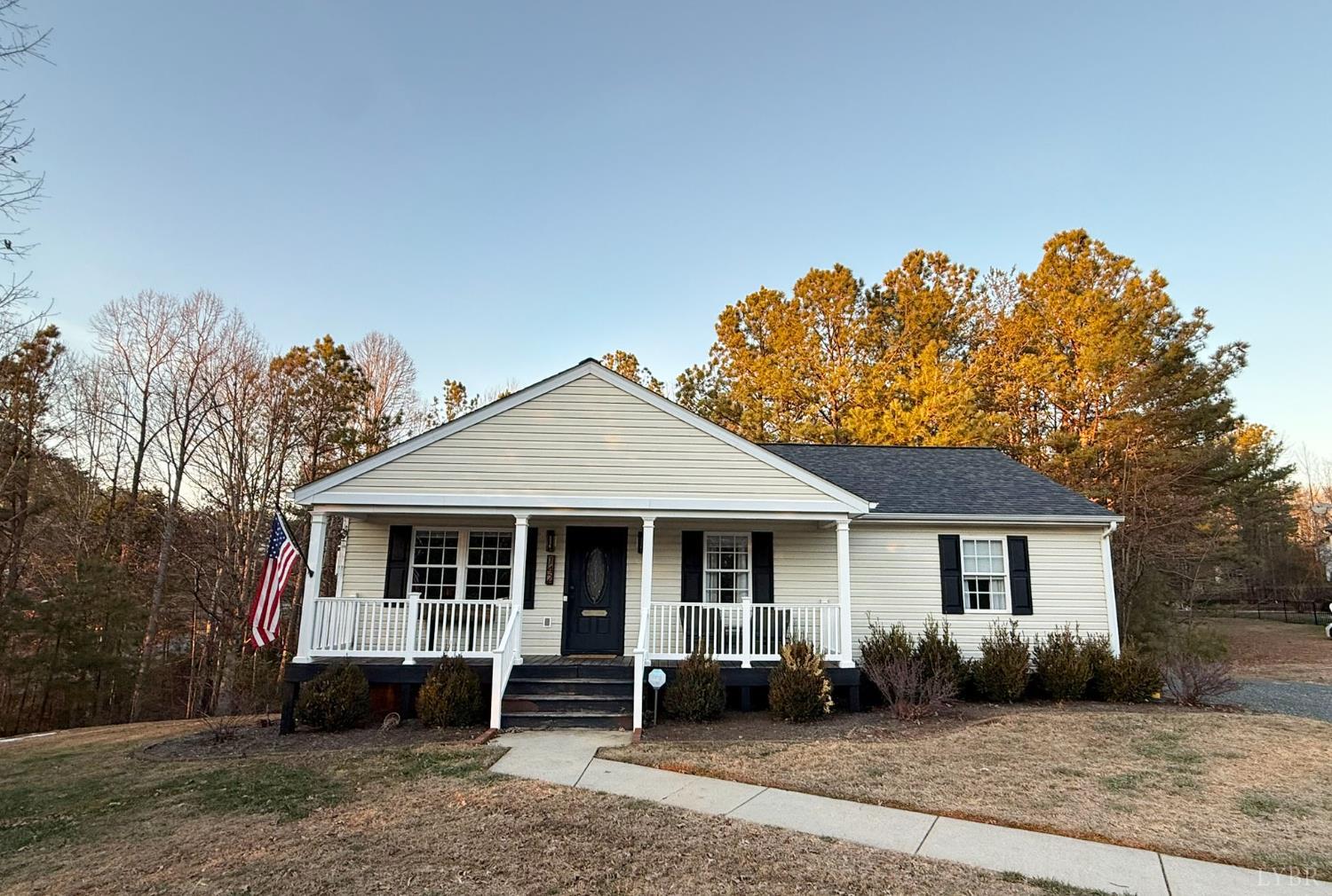 a front view of a house with a yard and parking space