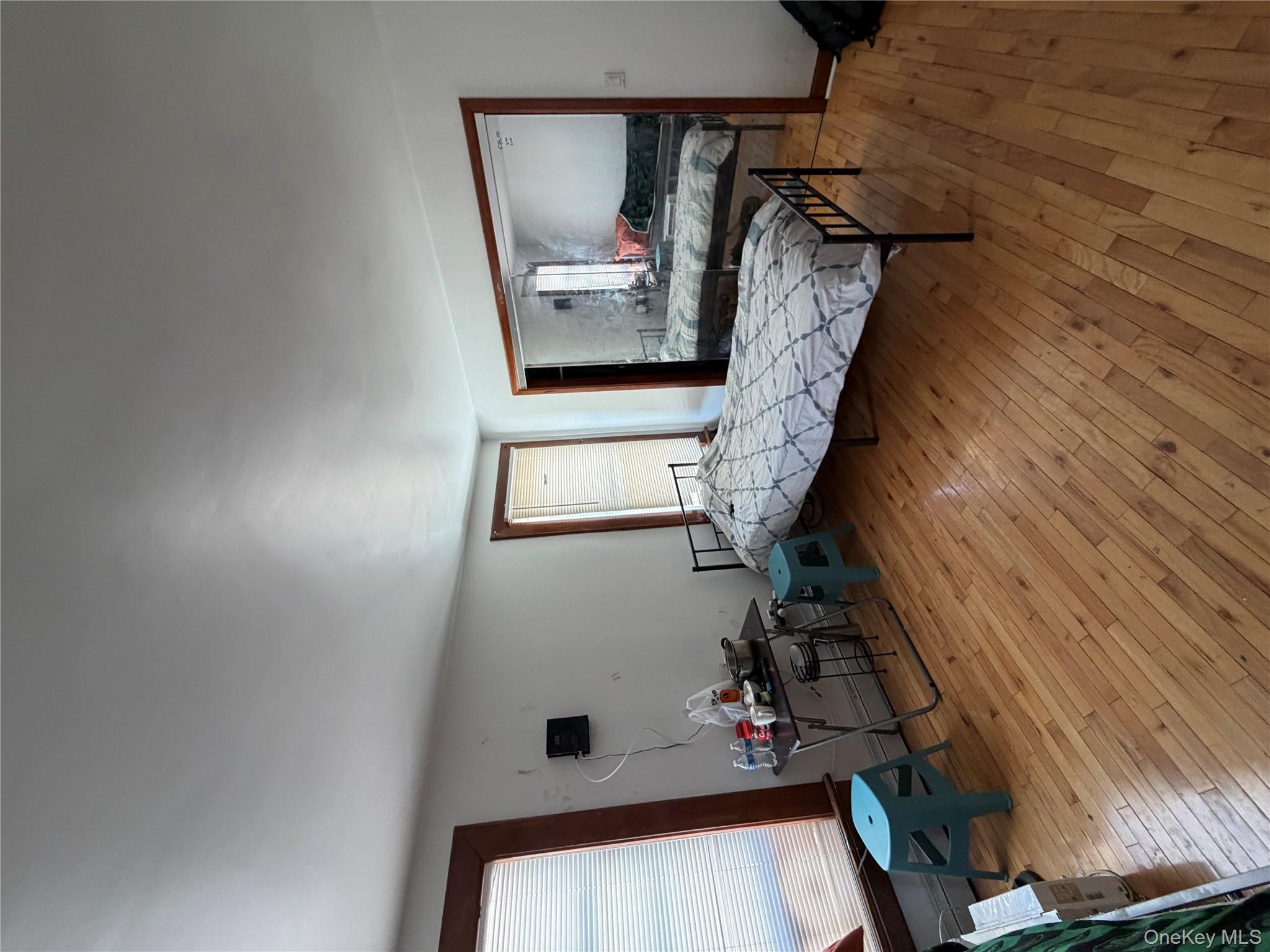 35-13 103rd Street Queens, NY 11368 - Photo 11 of 13 a living room with furniture and a wooden floor