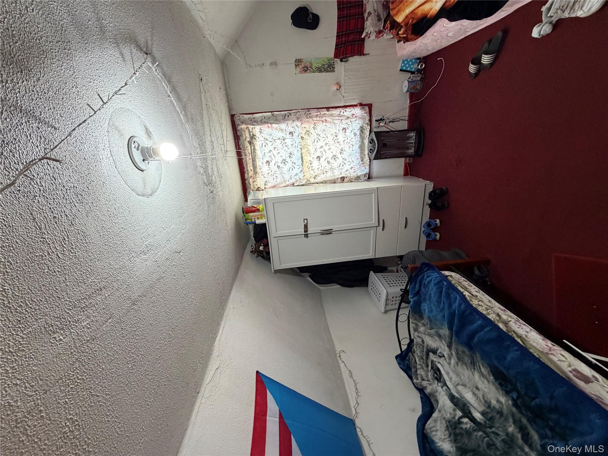 35-13 103rd Street Queens, NY 11368 - Photo 12 of 13 a room with furniture and window