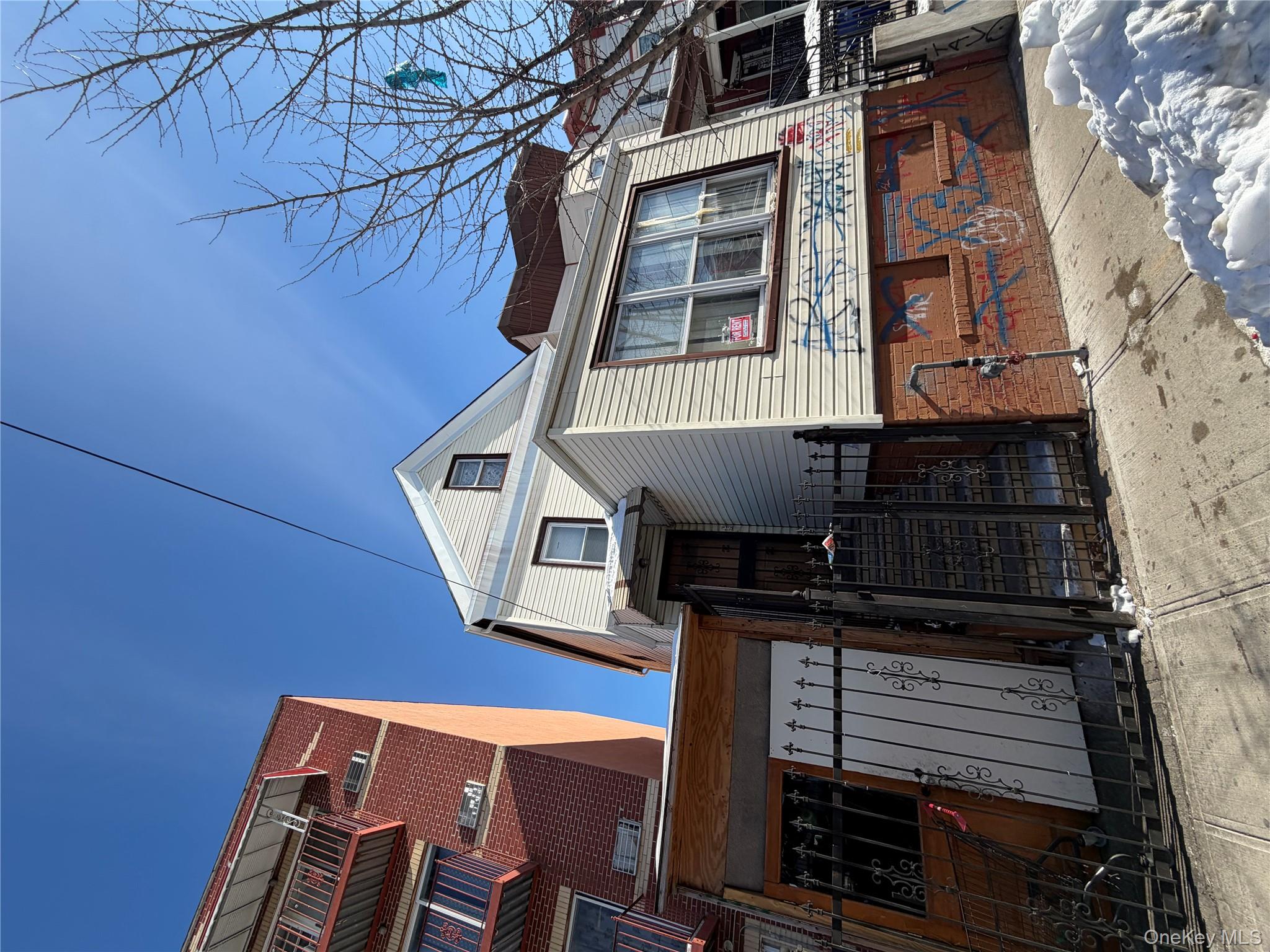 35-13 103rd Street Queens, NY 11368 - Photo 2 of 13 a front view of a house with a yard