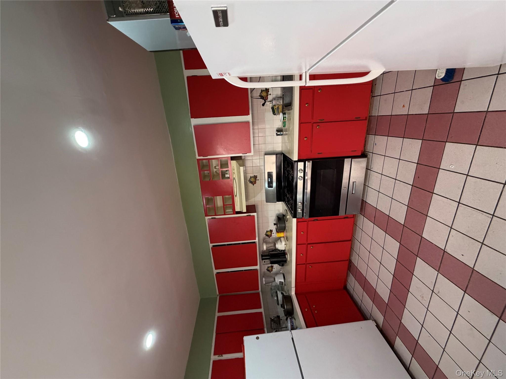 35-13 103rd Street Queens, NY 11368 - Photo 4 of 13 a kitchen with stainless steel appliances granite countertop a stove a sink dishwasher and a refrigerator