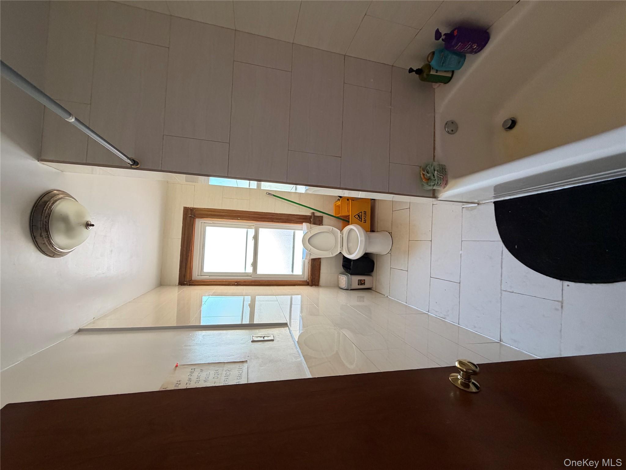 35-13 103rd Street Queens, NY 11368 - Photo 7 of 13 a bathroom with a tub sink and mirror