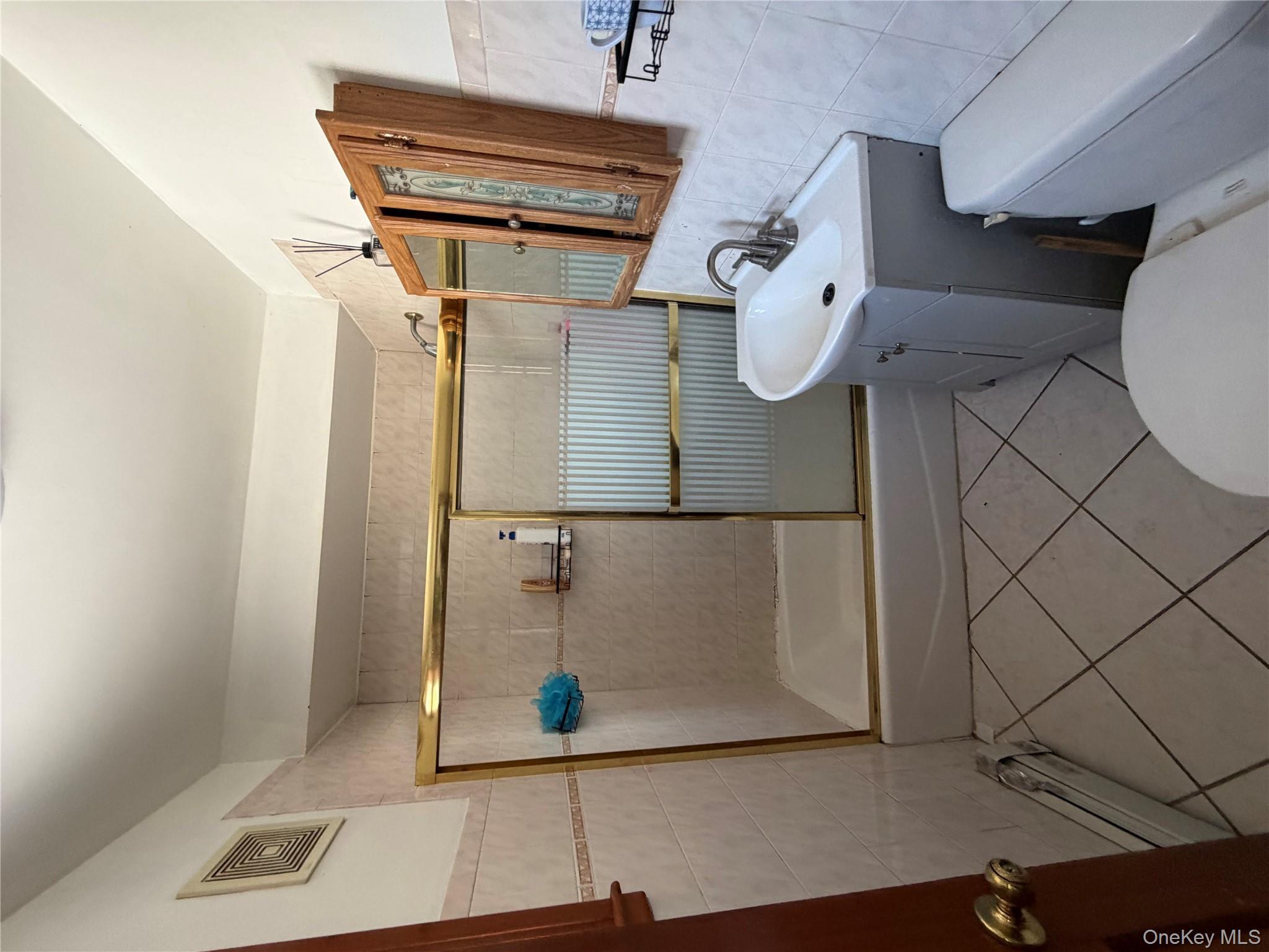 35-13 103rd Street Queens, NY 11368 - Photo 8 of 13 a bathroom with a sink toilet and shower