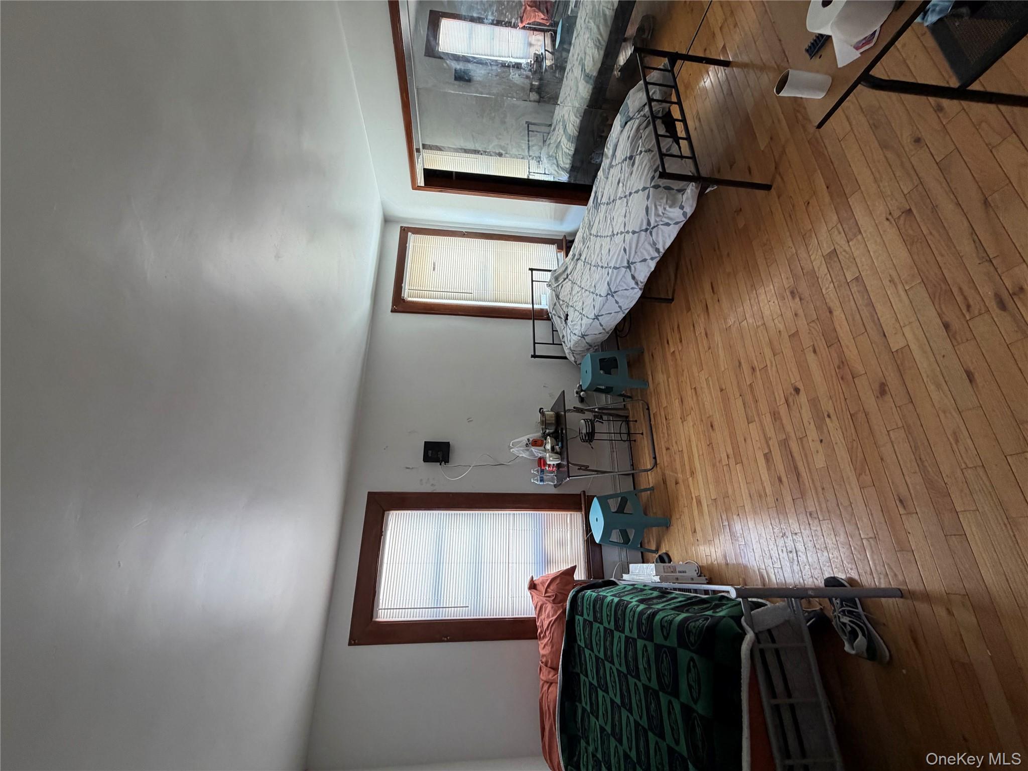 35-13 103rd Street Queens, NY 11368 - Photo 9 of 13 a living room with furniture and a wooden floor