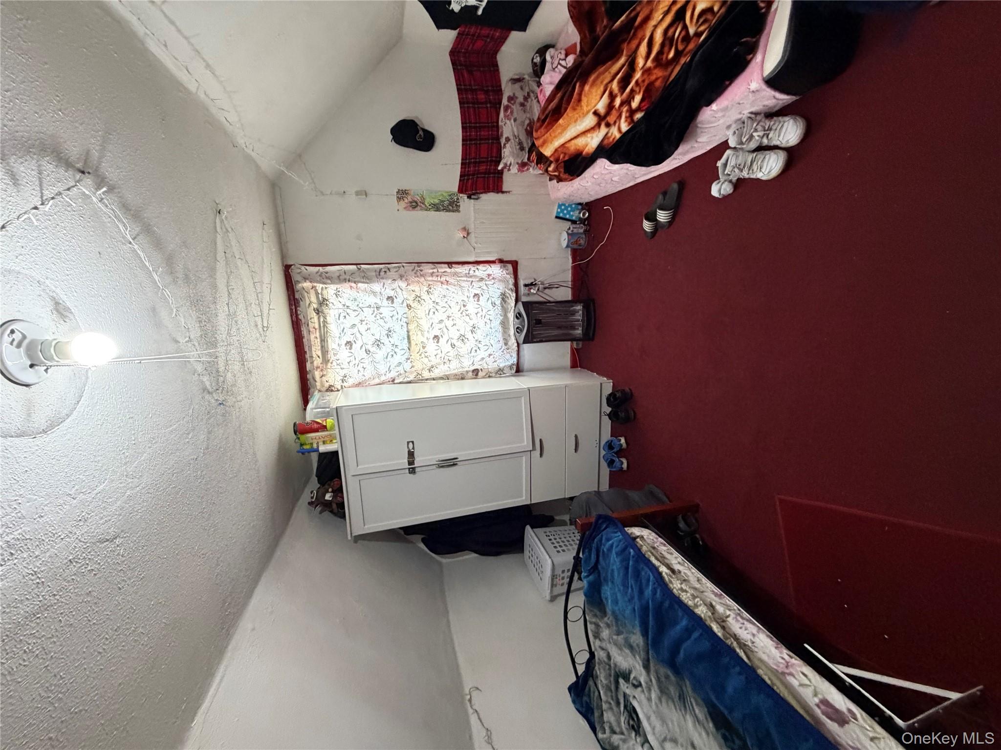 35-13 103rd Street Queens, NY 11368 - Photo 10 of 13 a room with furniture and a window
