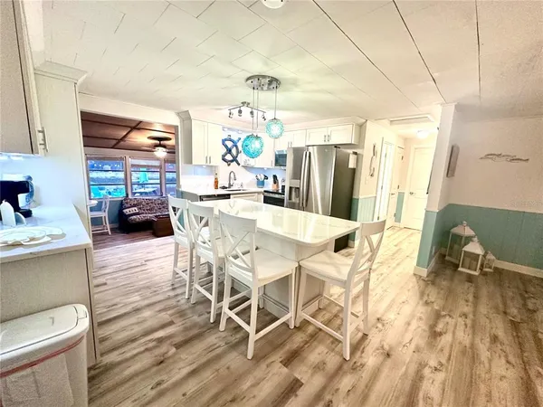 a dining room with furniture and wooden floor