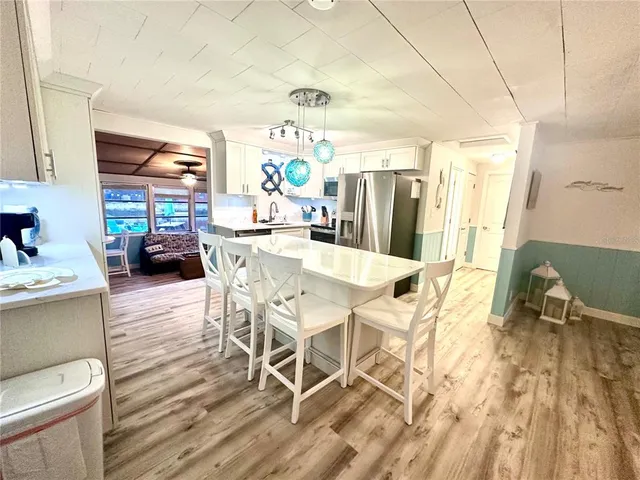 a dining room with furniture and wooden floor