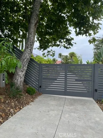 a view of a tree with wooden fence