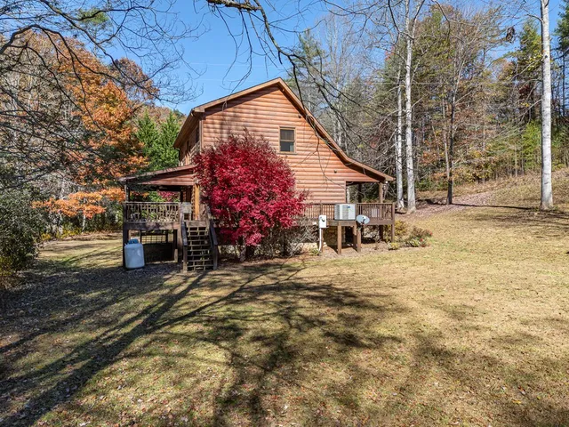 a view of a house with backyard porch and sitting area