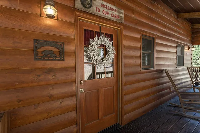 a living room with furniture a bed and a large window